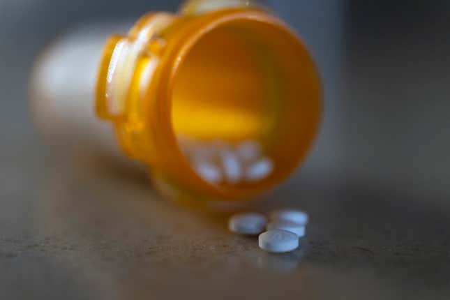 Open prescription drug bottle. 